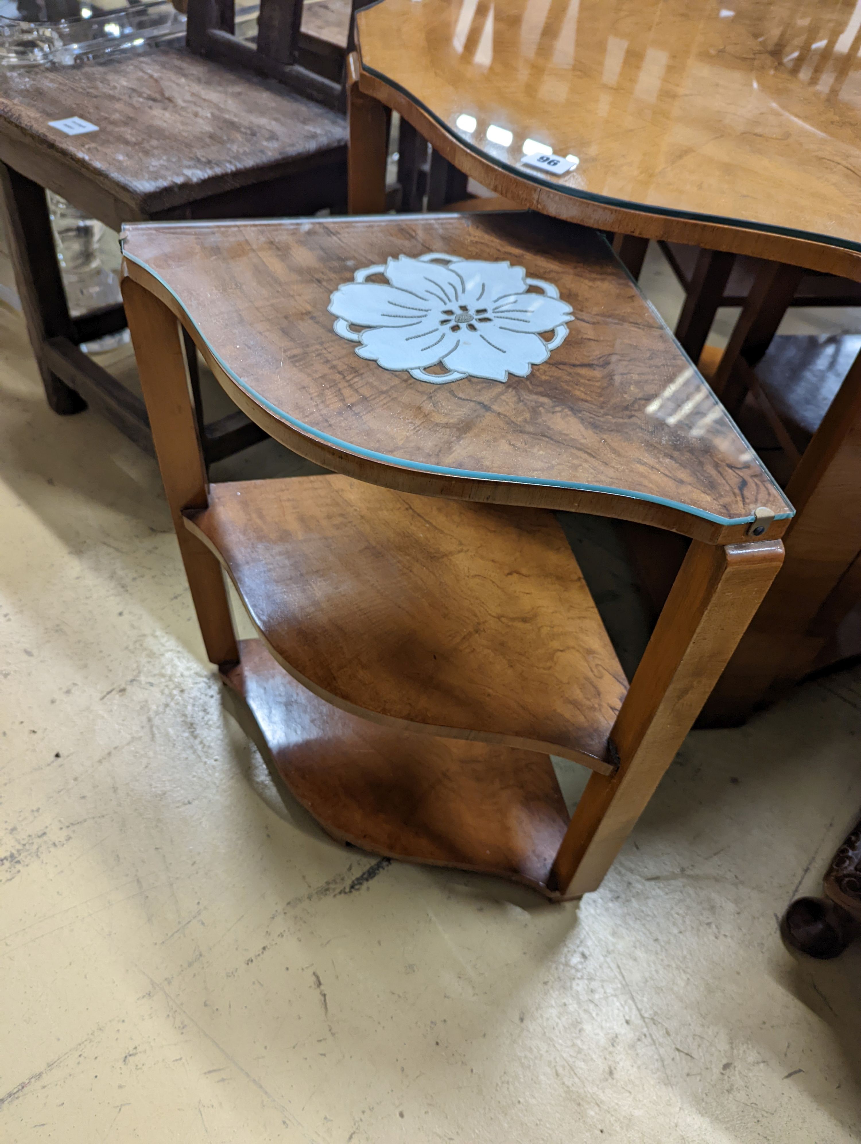 An Art Deco style cross banded walnut nest of tables of circular serpentine form, diameter 72cm, height 54cm